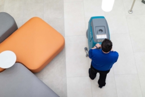 Carpet and Floor Care Services associate performing professional floor cleaning and polishing of a commercial workplace